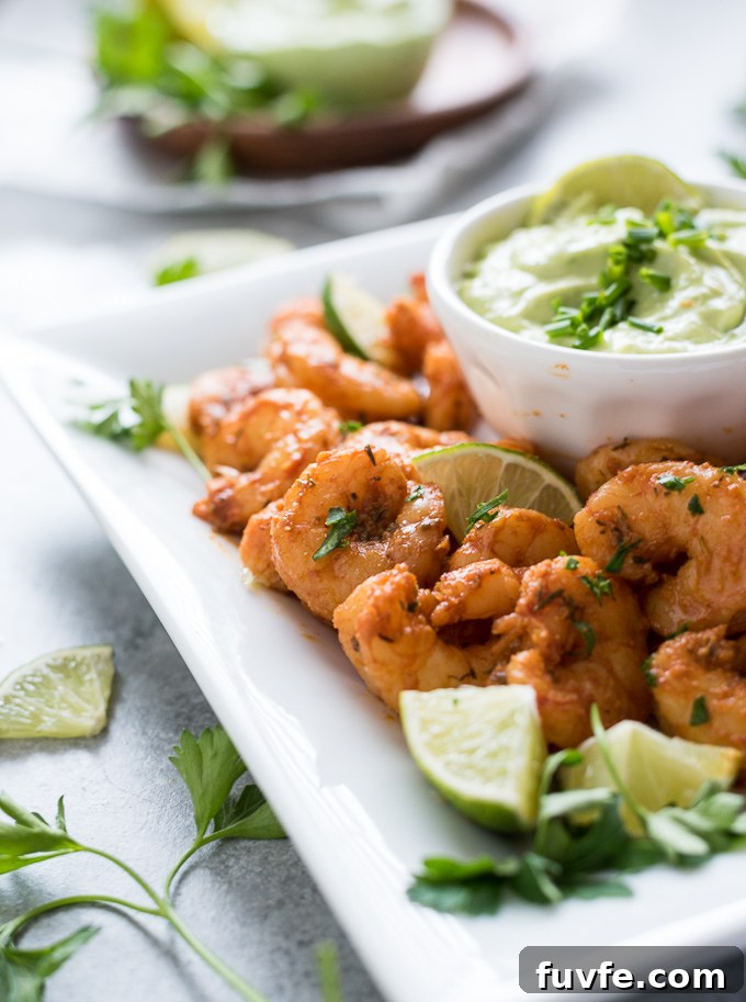 Blackened shrimp on a platter with dip
