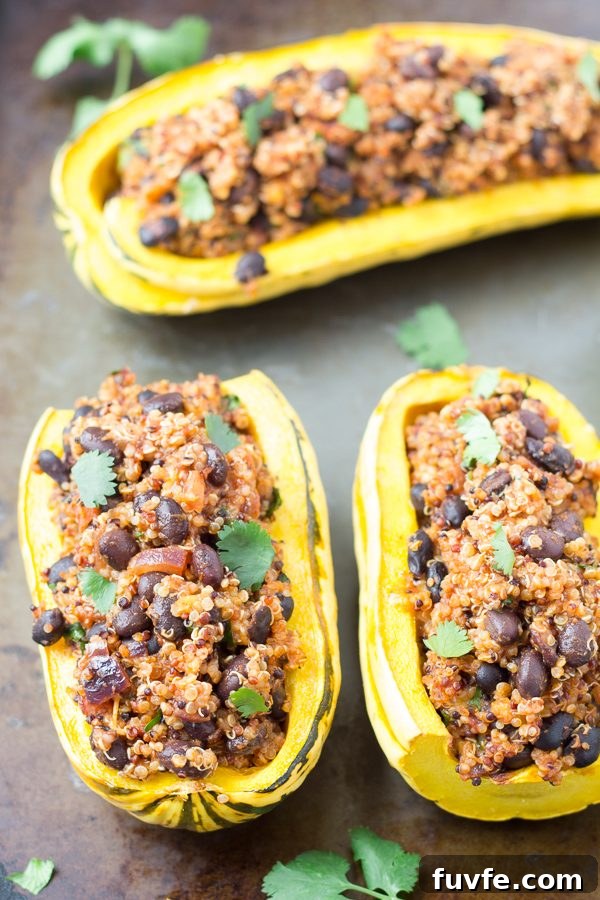 Stuffed delicata squash on a baking sheet