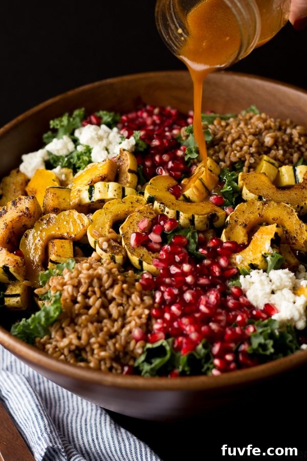 Delicata squash salad being drizzled with dressing