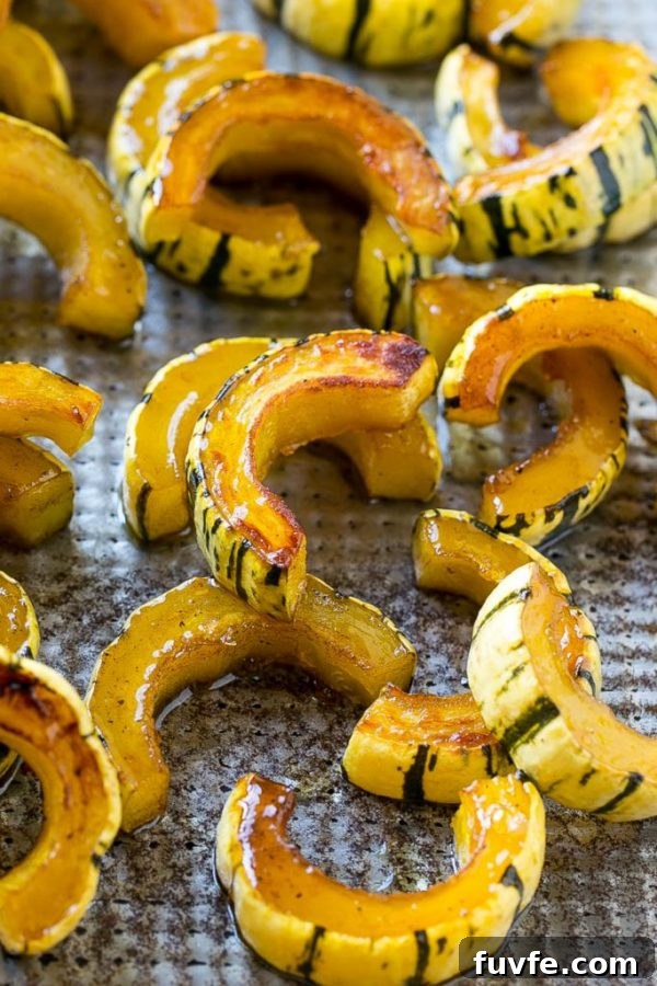 Roasted delicata squash on a baking tray.