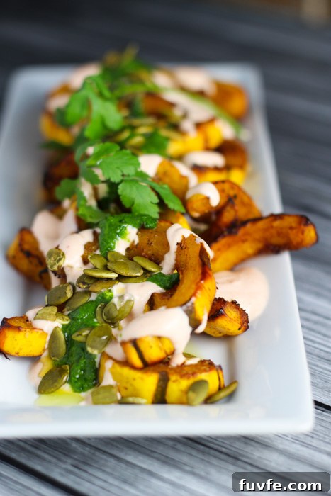 Roasted squash on a platter with yogurt cilantro sauce