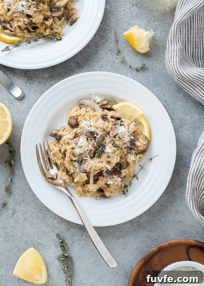 Instant pot risotto with mushrooms on a plate with lemon and thyme