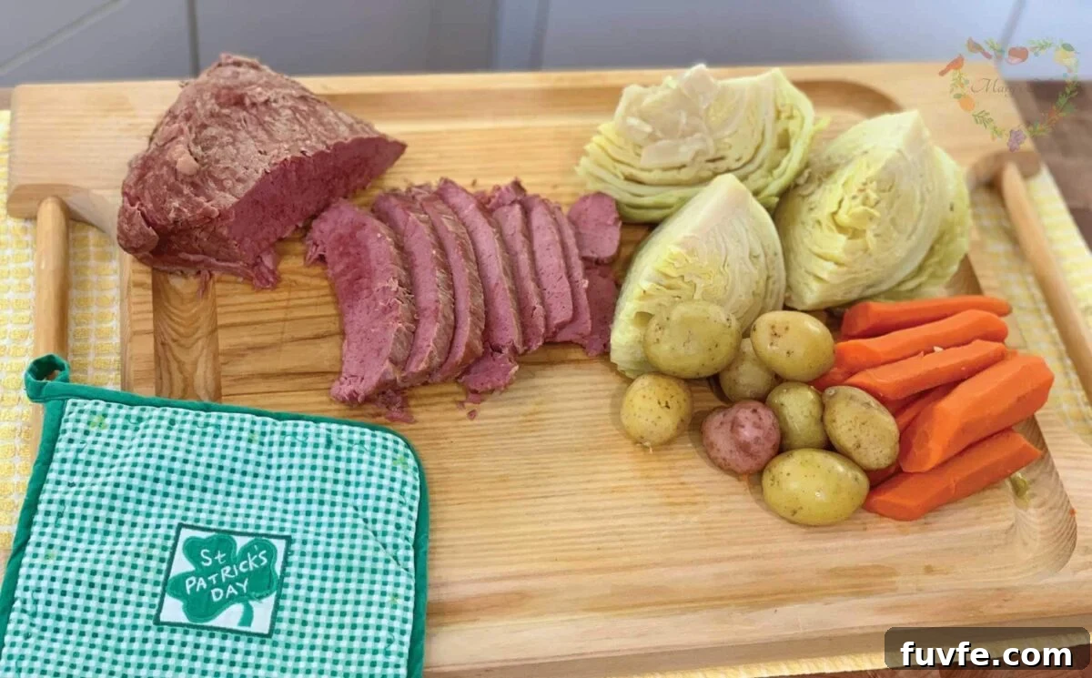 Corned Beef, Cabbage, Potatoes, and carrots on a tray with a St Patricks Day potholder.