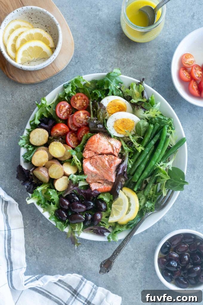 Salmon nicoise salad with ingredients surrounding