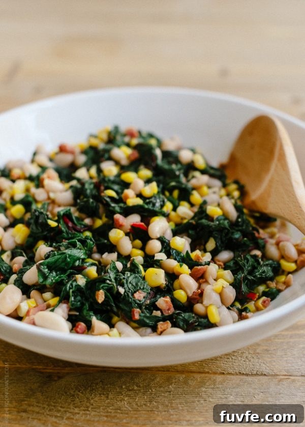 Swiss chard with pancetta, corn and beans in white bowl