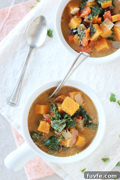 Sweet potato swiss chard soup in bowl with spoon