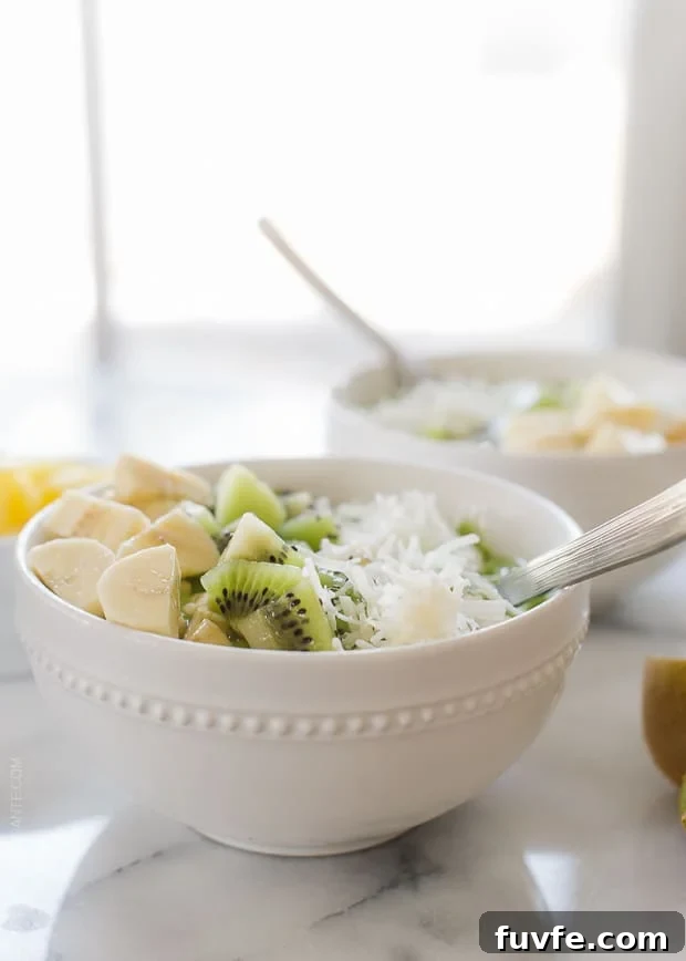 Green Smoothie Bowl topped with kiwi and banana in a white bowl