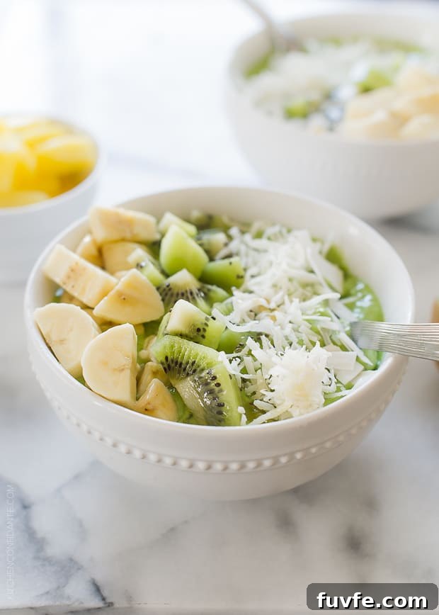 Green Smoothie Bowl topped with kiwi and banana in a white bowl