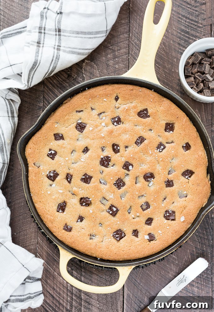 Gooey Cast Iron Chocolate Chip Skillet Cookie 3 Skillet cookie in the pan with chocolate chunks and flaky sea salt on top