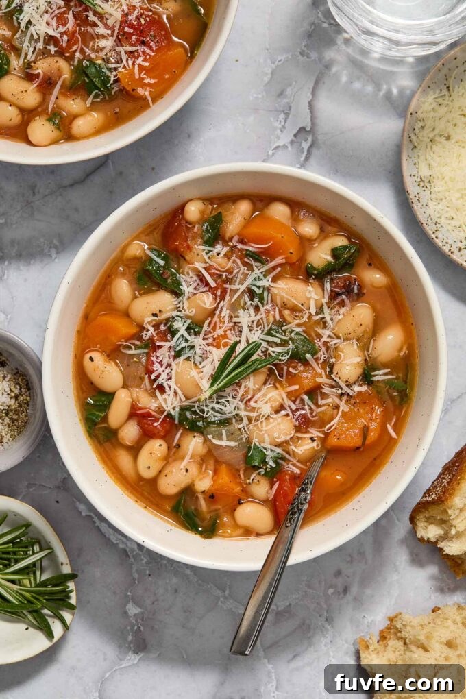 Hearty Instant Pot White Bean Stew 2 Bowl of vegetarian white bean stew topped with rosemary and parmesan.