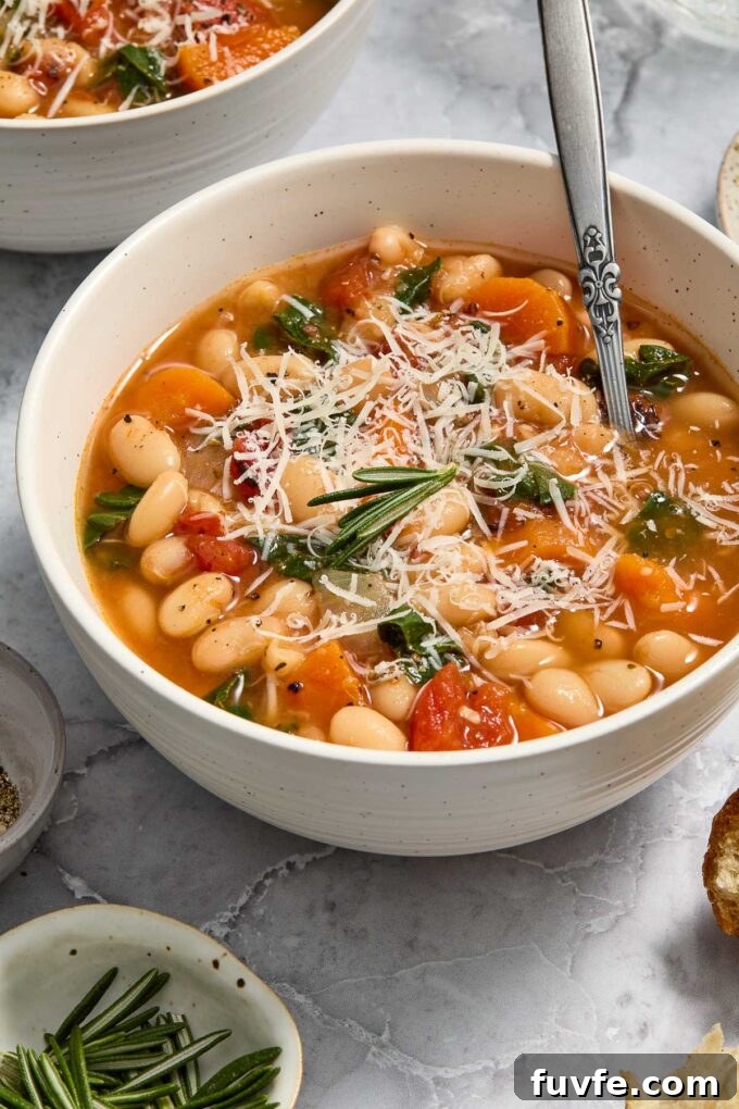 Hearty Instant Pot White Bean Stew 6 Chard and white bean stew in a bowl with a spoon.
