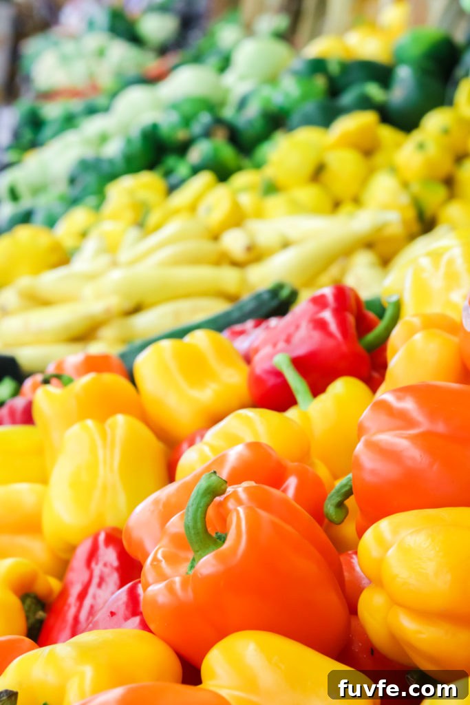 rainbow peppers are in season and displayed at a produce stand