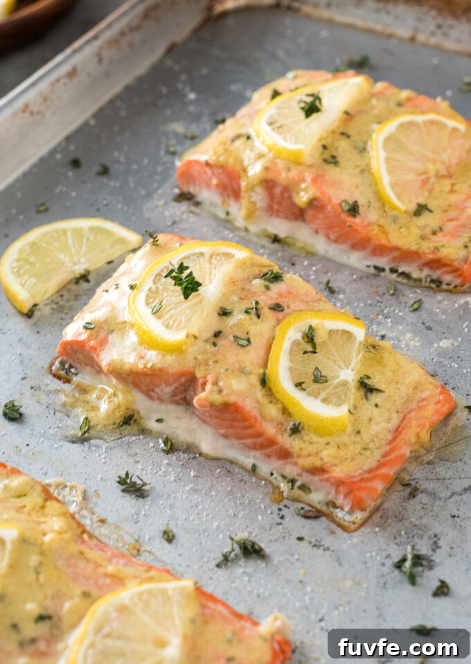 Baked salmon with dijon mustard sauce on sheet pan.