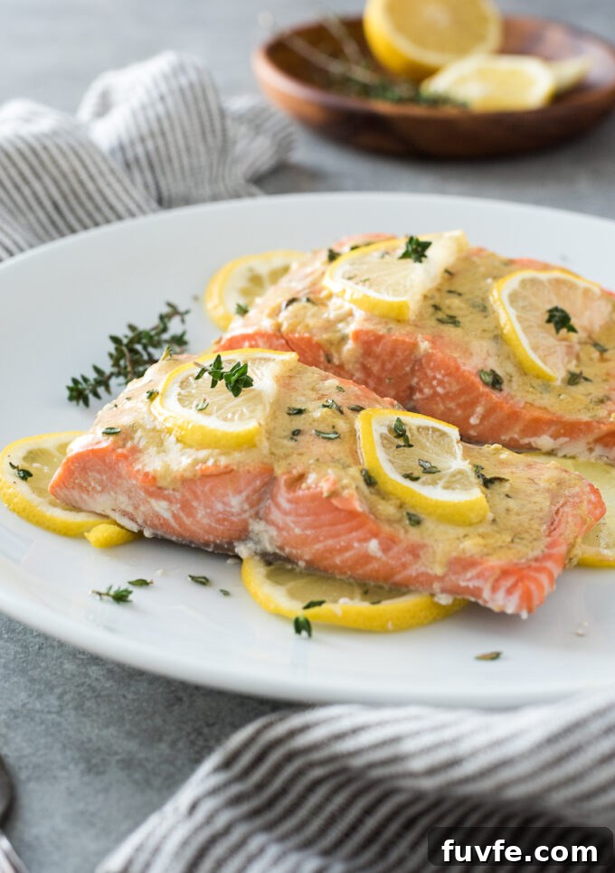 Baked Lemon Dijon Salmon Recipe 7 Lemon dijon salmon with lemon slices on a plate.