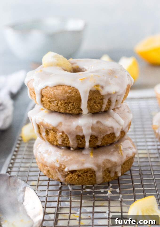 Baked Lemon Donuts Recipe with Zesty Glaze 6 Stack of glazed lemon donuts.