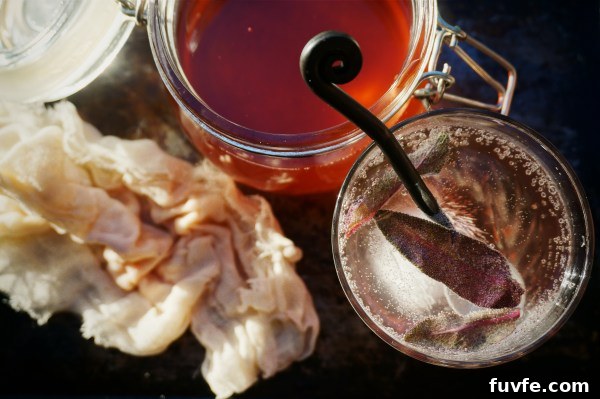 Rhubarb shrub in a jar, next to a glass of homemade rhubarb soda.