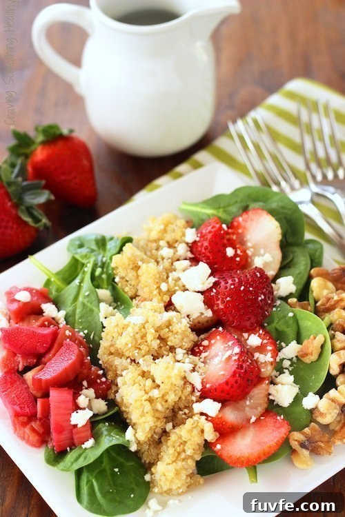Strawberry rhubarb salad on a white plate.