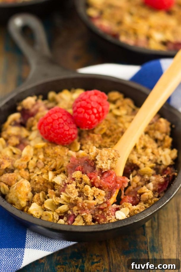 A mini raspberry rhubarb crisp in a small cast iron skillet.