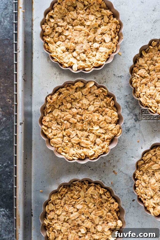 Granola tart shells baked in mini tart pans.