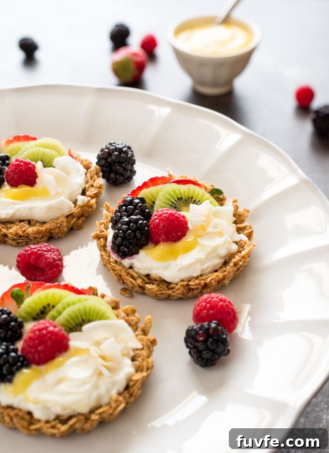 Yogurt fruit tarts with granola crust and fresh berries.