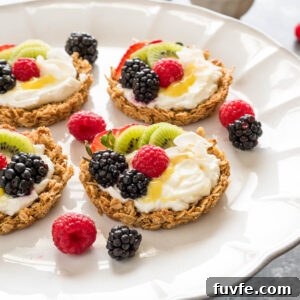 breakfast fruit tarts with granola crust, yogurt filling, and fresh fruit.