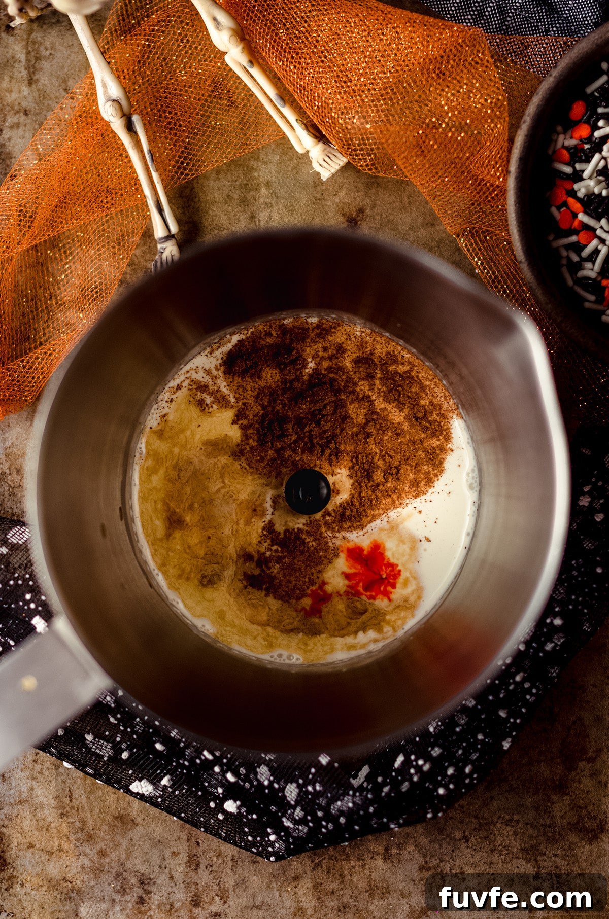 Iced Witches’ Brew Coffee: Spiced Cold Brew Recipe for Fall 6 aerial photo of milk frother with pumpkin spice cold foam ingredients in it