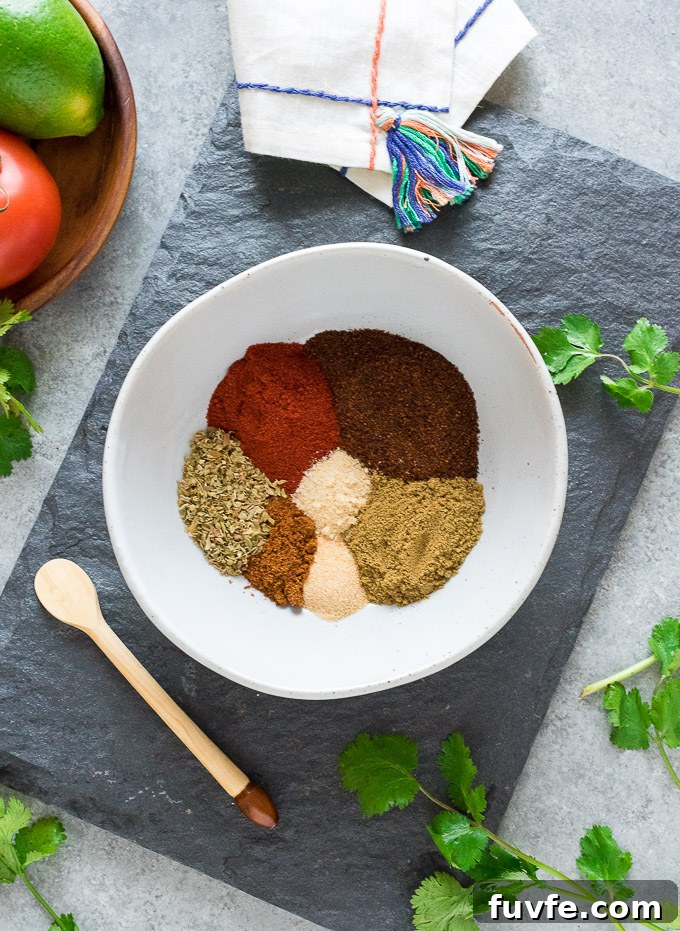 Homemade Taco Seasoning Mix Recipe for Authentic Flavor 3 Taco seasoning ingredients sectioned in a bowl