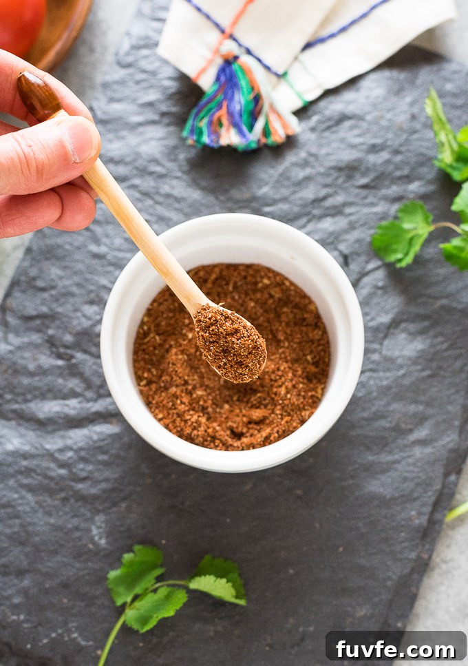 Homemade Taco Seasoning Mix Recipe for Authentic Flavor 7 Spoonful of Mexican spice mix over a bowl