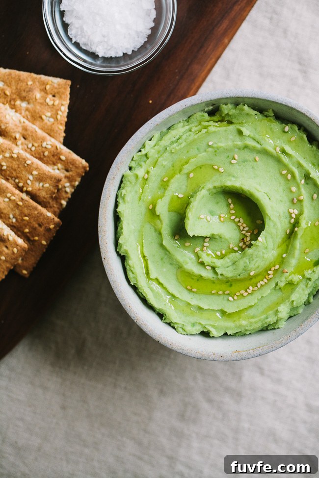 Fava bean puree in a bowl with sesame seeds on top