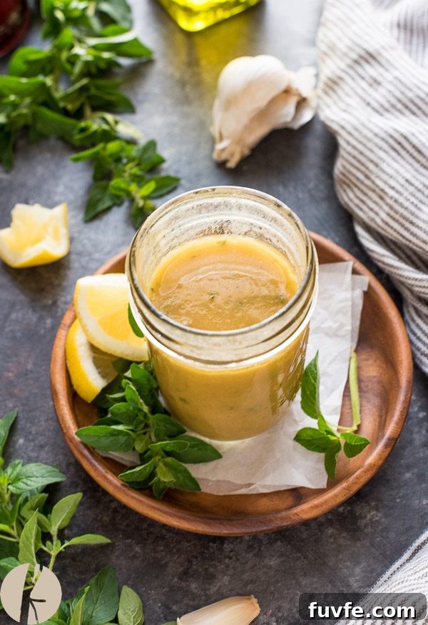 Classic Greek Salad Dressing Recipe 2 Greek dressing in mason jar with oregano and lemon