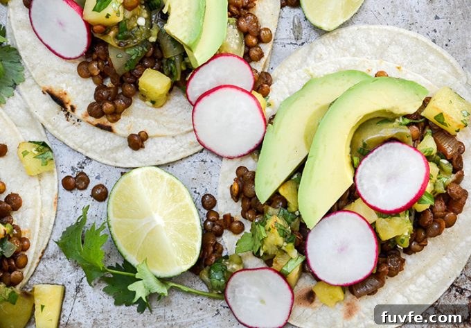 Overhead view of two lentil tacos with pineapple-tomatillo salsa.