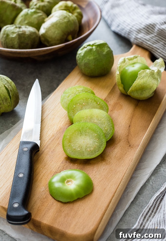 27 Tomatillo Recipes and How to Buy, Store, and Cook 5 Sliced tomatillo on a cutting board with a knife