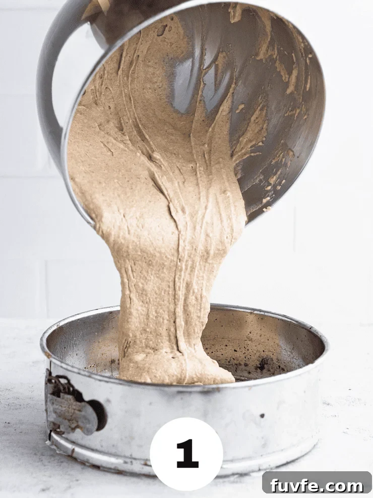 Norwegian Spice Cake Recipe: Classic Krydderkake with Warm Spices 5 Thick, beige batter being poured into a silver springform pan.