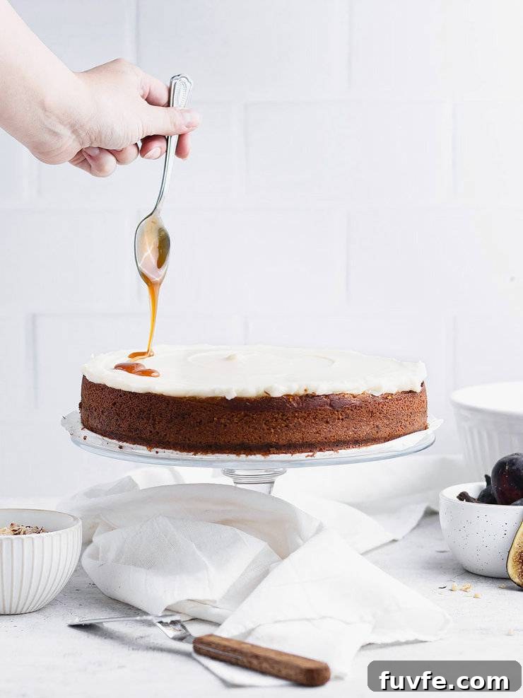 Norwegian Spice Cake Recipe: Classic Krydderkake with Warm Spices 9 Hand drizzling caramel over a single layer spice cake topped with cream cheese frosting.