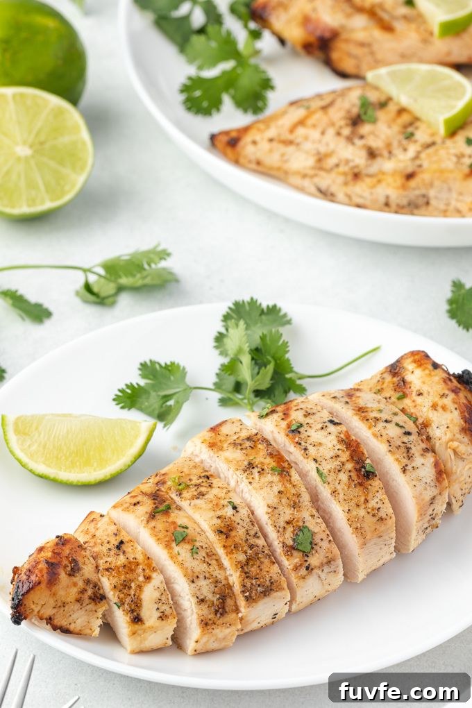 Sliced tequila lime chicken breast on a white plate