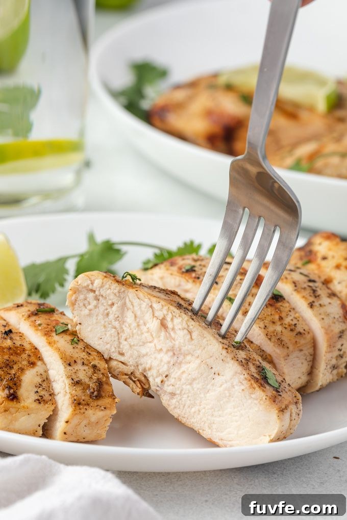 Fork digging into sliced tequila chicken