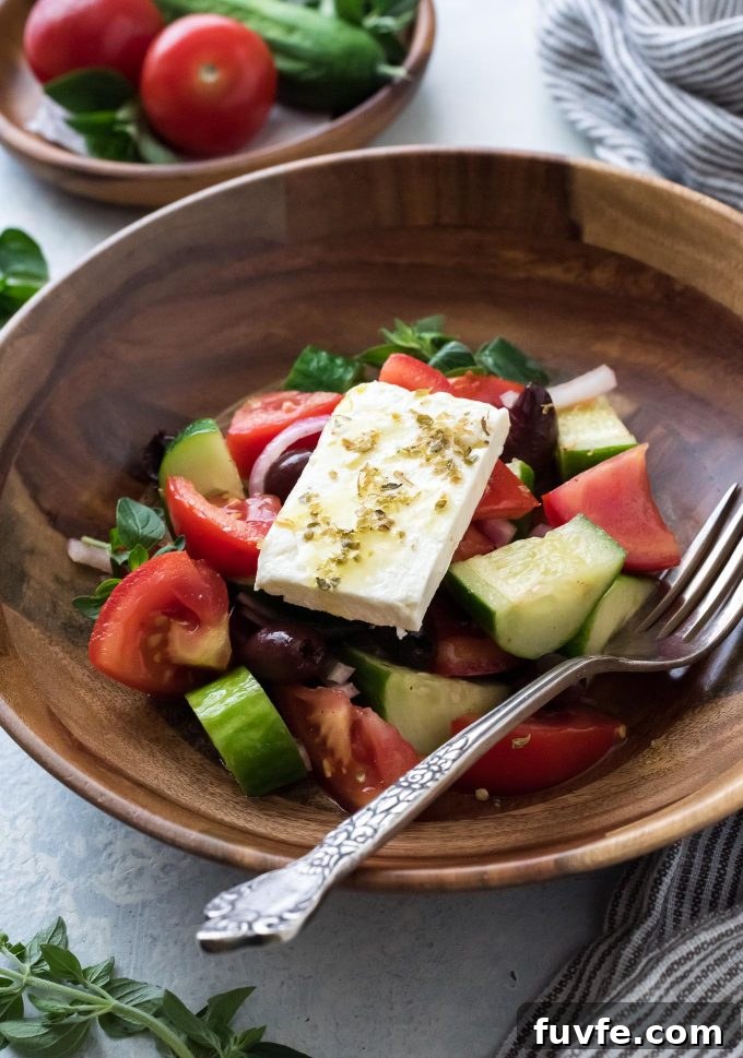 Horiatiki in a bowl with a fork