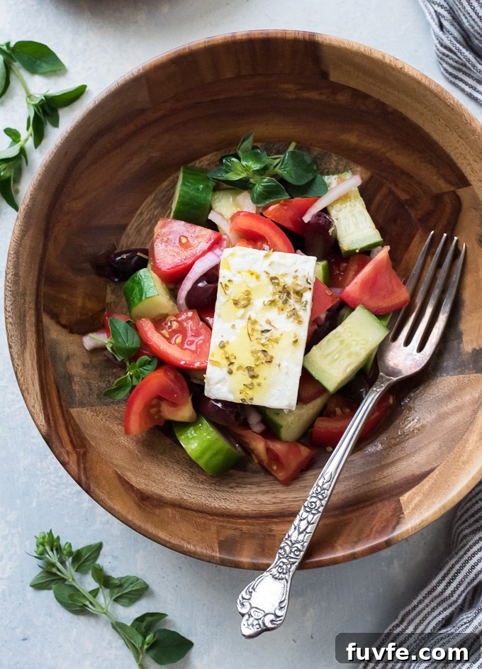 Horiatiki Greek Village Salad Recipe 3 Horiatiki salad in a teak bowl with block of feta on top
