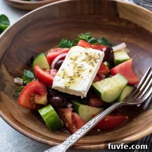 Horiatiki in a bowl with a fork