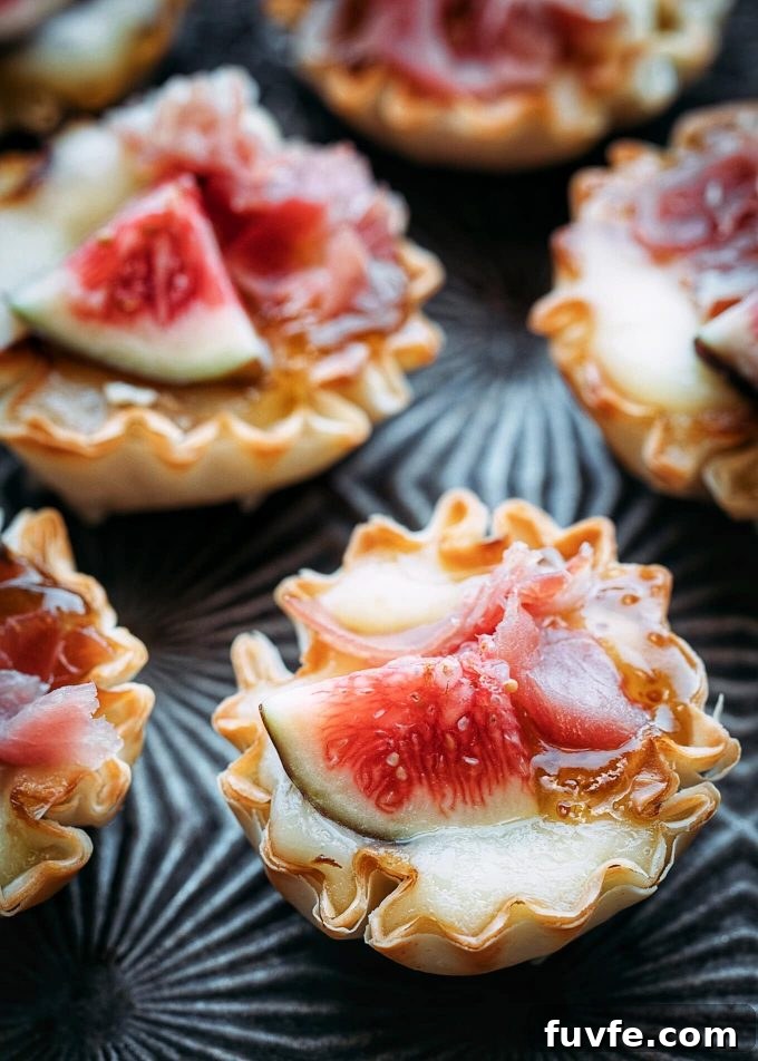 Close up shot of phyllo brie bites topped with figs.