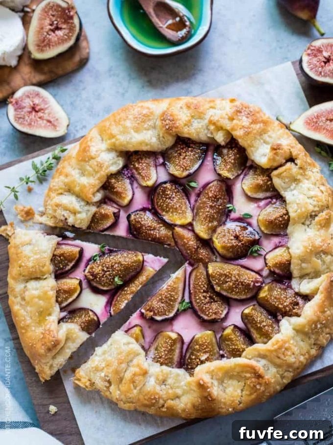 Overhead view of a fig and goat cheese galette. One slice has been cut and is about to be removed.