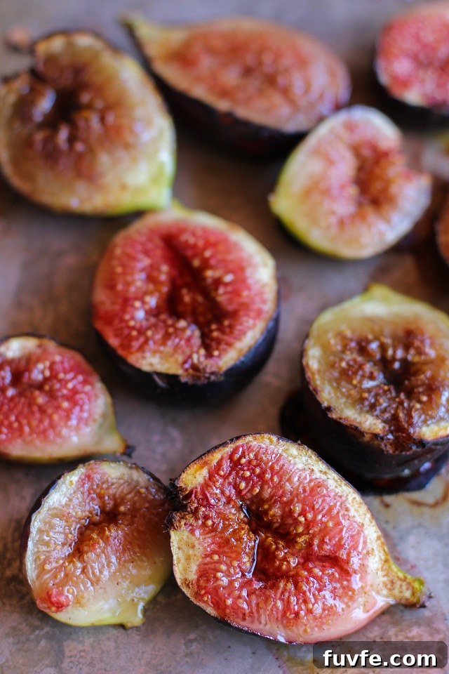 Maple roasted figs scattered on a baking tray.