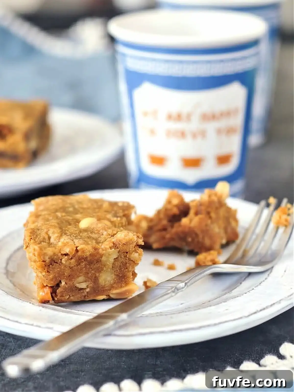 Vegan peanut butter bar on a rustic plate with a fork.