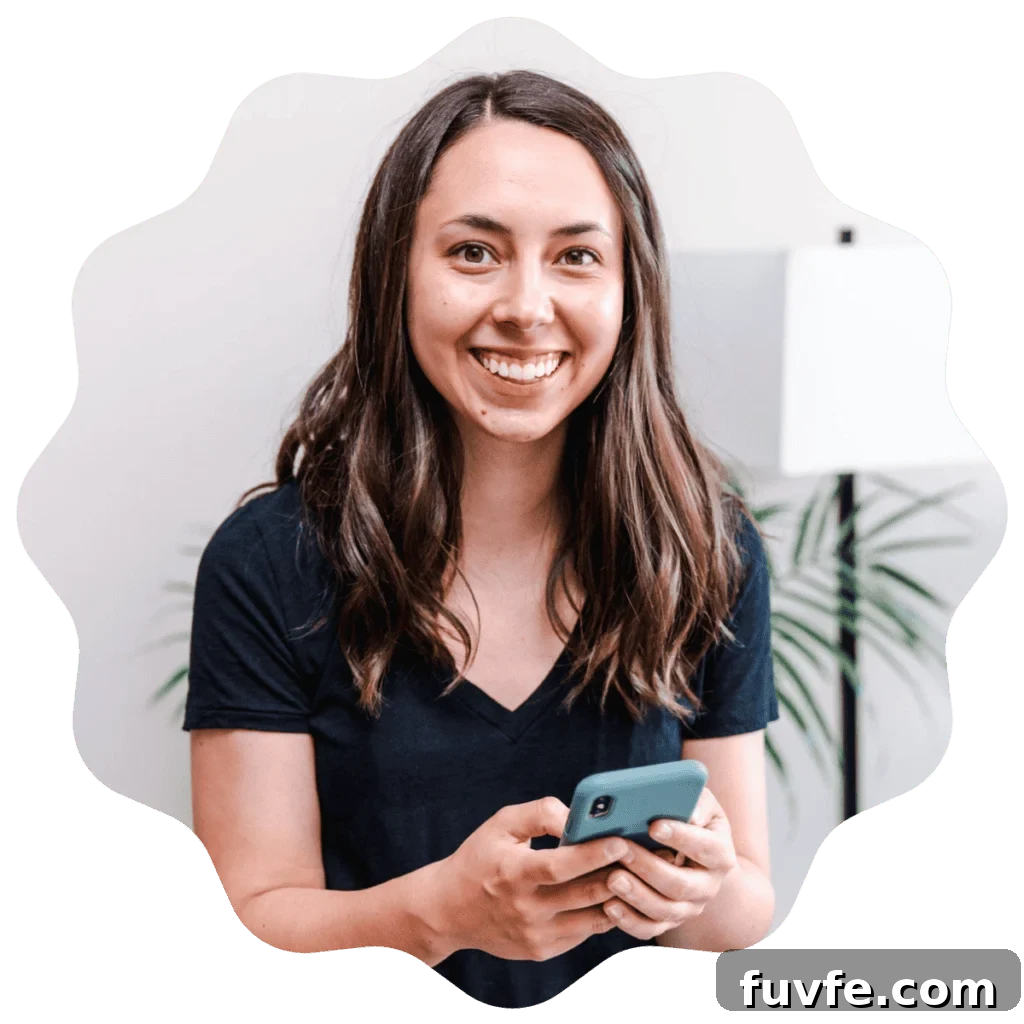 Kayla Burton from Broken Oven Baking Company holding a phone.