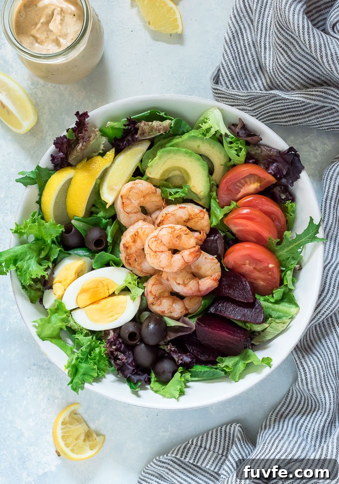 Shrimp louie salad in a white bowl with no dressing