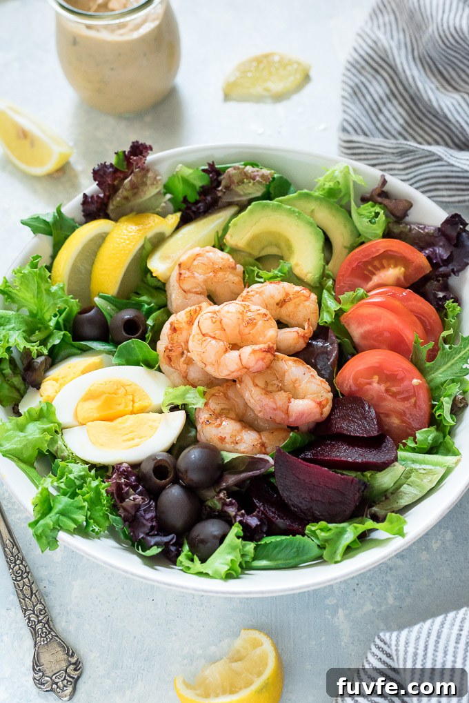 Grilled shrimp louie salad with dressing in a jar