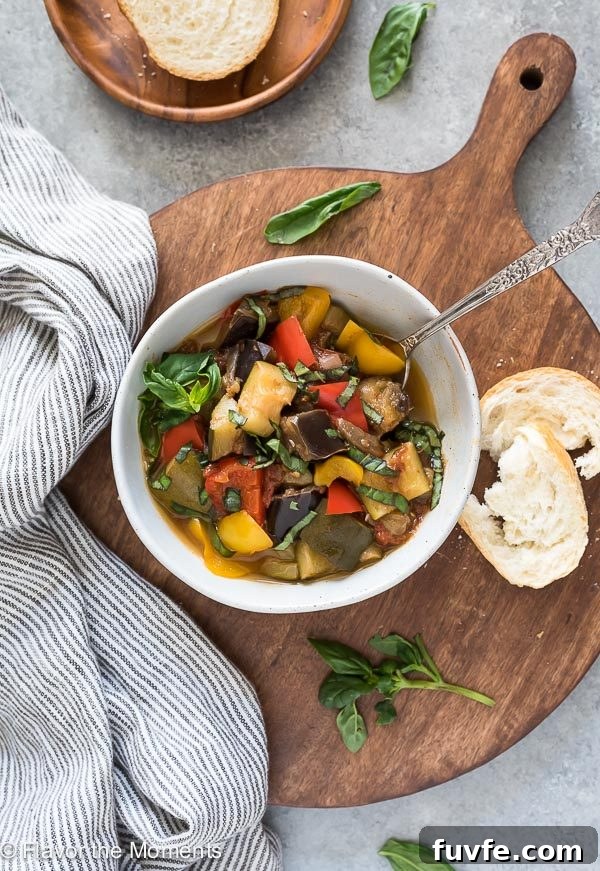 bowl of ratatouille with spoon inside and bread