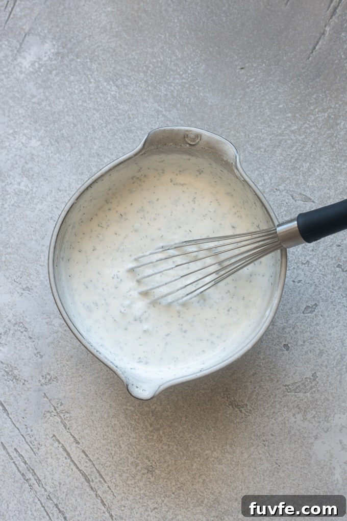 Creamy Homemade Greek Yogurt Ranch Dressing Recipe 5 Ingredients for ranch dressing using Greek yogurt combined in a bowl.