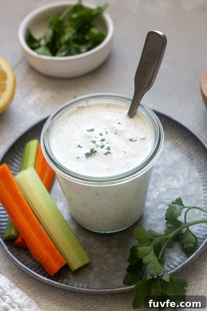 Creamy Homemade Greek Yogurt Ranch Dressing Recipe 7 Jar of Greek yogurt ranch dressing in a jar with parsley on top.