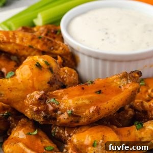 Instant pot chicken wings piled on a plate with ranch dip